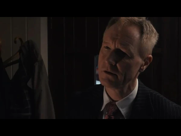 A man with a serious expression appears deep in thought in "Saudade".