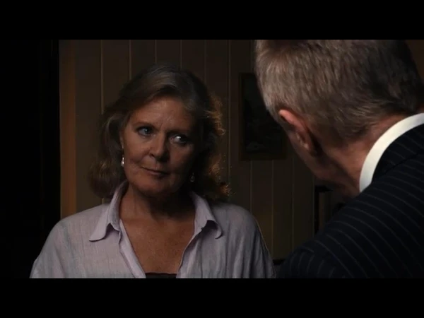 An older woman has an intense conversation with a man in "Saudade".