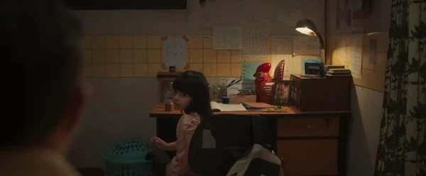 Little Intan is seen in a room, possibly studying or working in "Panggil Aku Ayah".