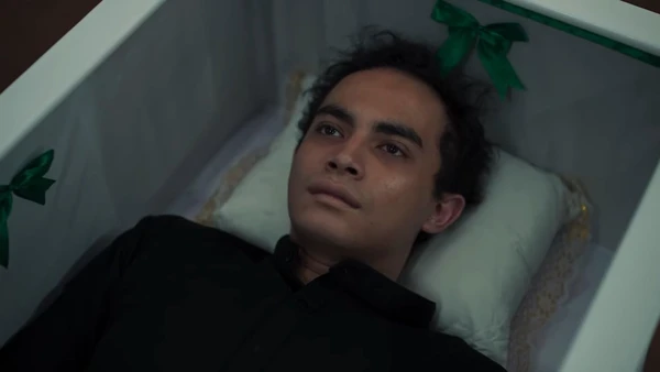A young man lies in a coffin in "Tinggal Meninggal".